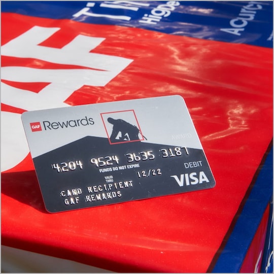 GAF rewards card for roofing contractors on top of Timberline shingles.