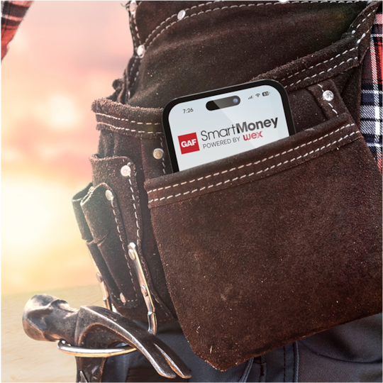 Smartphone showing GAF SmartMoney app in a leather tool belt worn by a GAF certified contractor.