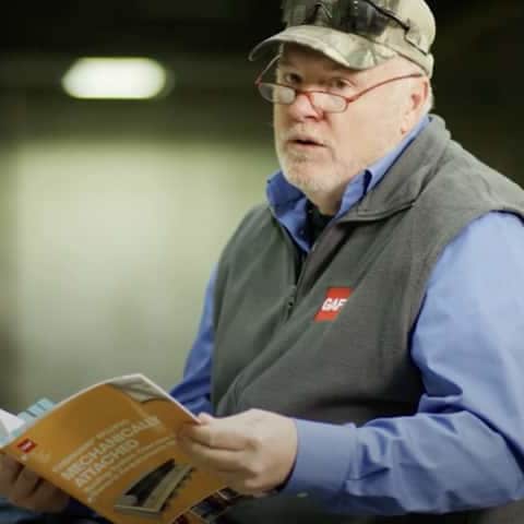 Dave and Wally discussing mod-bit reroof options on top of a flt roof