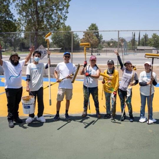 GAF roofing employees coating roads to help communities and sustainability initiatives.