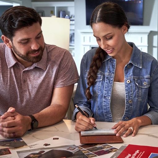 Man and woman homeowners reviewing warranty options