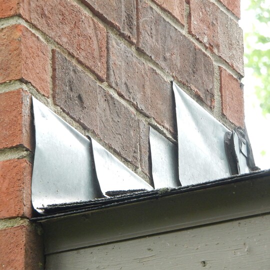 Damaged flashing on a roof letting in moisture. 