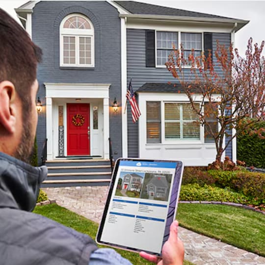 A contractor looking at a GAF ScopeConnect report bundled with a GAF QuickMeasure roof measurement report