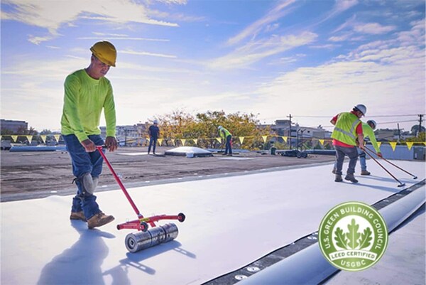 Contractors adding new roof materials onto GAF headquarters, the first building awared a LEED Resilient Pilot Credit. 