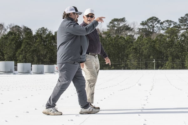 Two men on top of new GAF flat roof