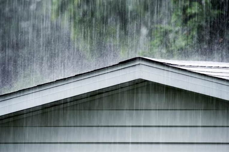 Heavy rain pouring on a roof during a hurricane