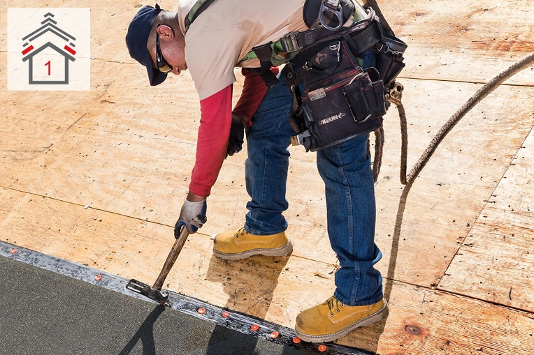 Roofing contractor installing GAF leak barrier