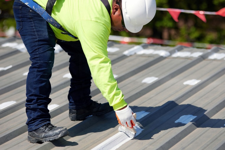 Roofing contractor treating seams