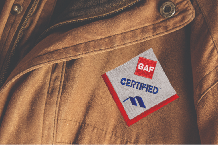 Close-up of jacket with GAF certified contractor diamond badge