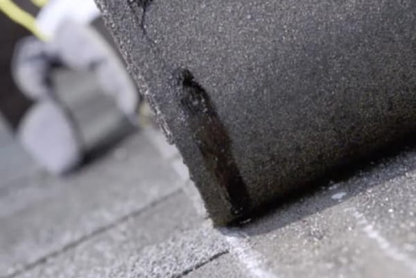 Close-up of GAF roofing shingle back with Dura Grip adhesive