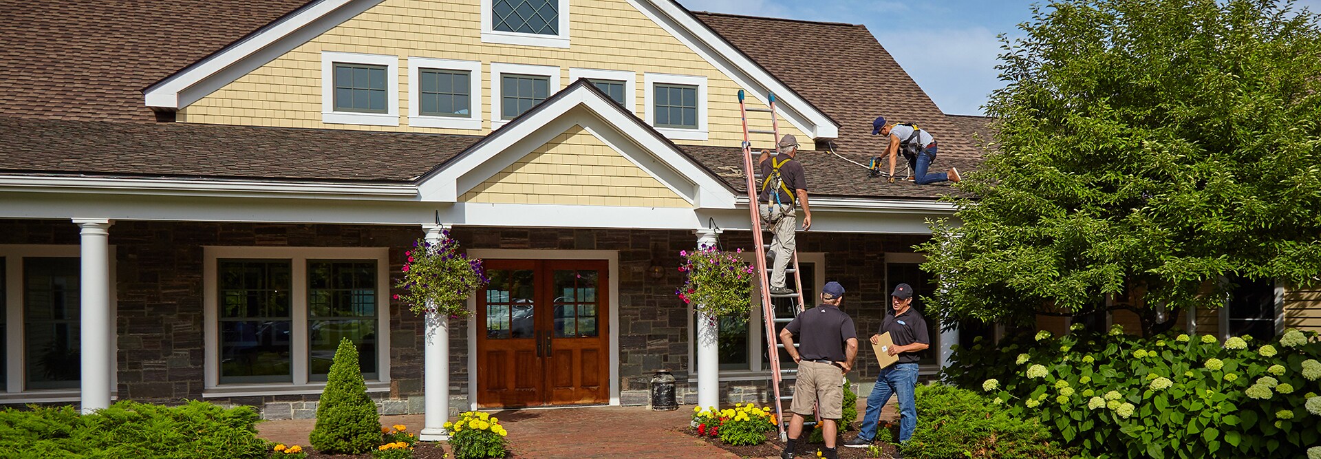 GAF certified contractors completing a storm damage roofing replacement project