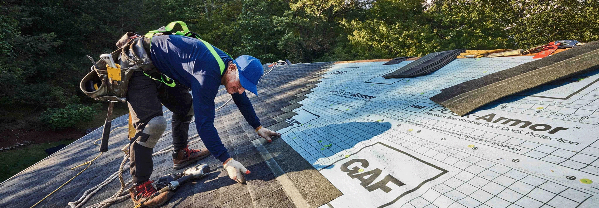 A GAF-certified roofer install a new roof on a house