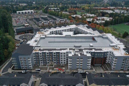 Aerial view of the Avalon Bothell Commons residential and mixed-use community rooftops