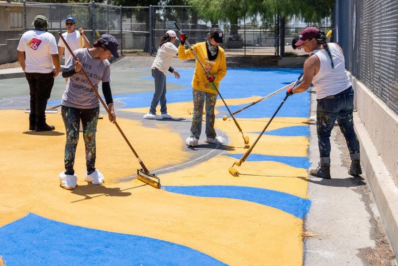 StreetBond employees helping to add cooling coatings to neighborhood