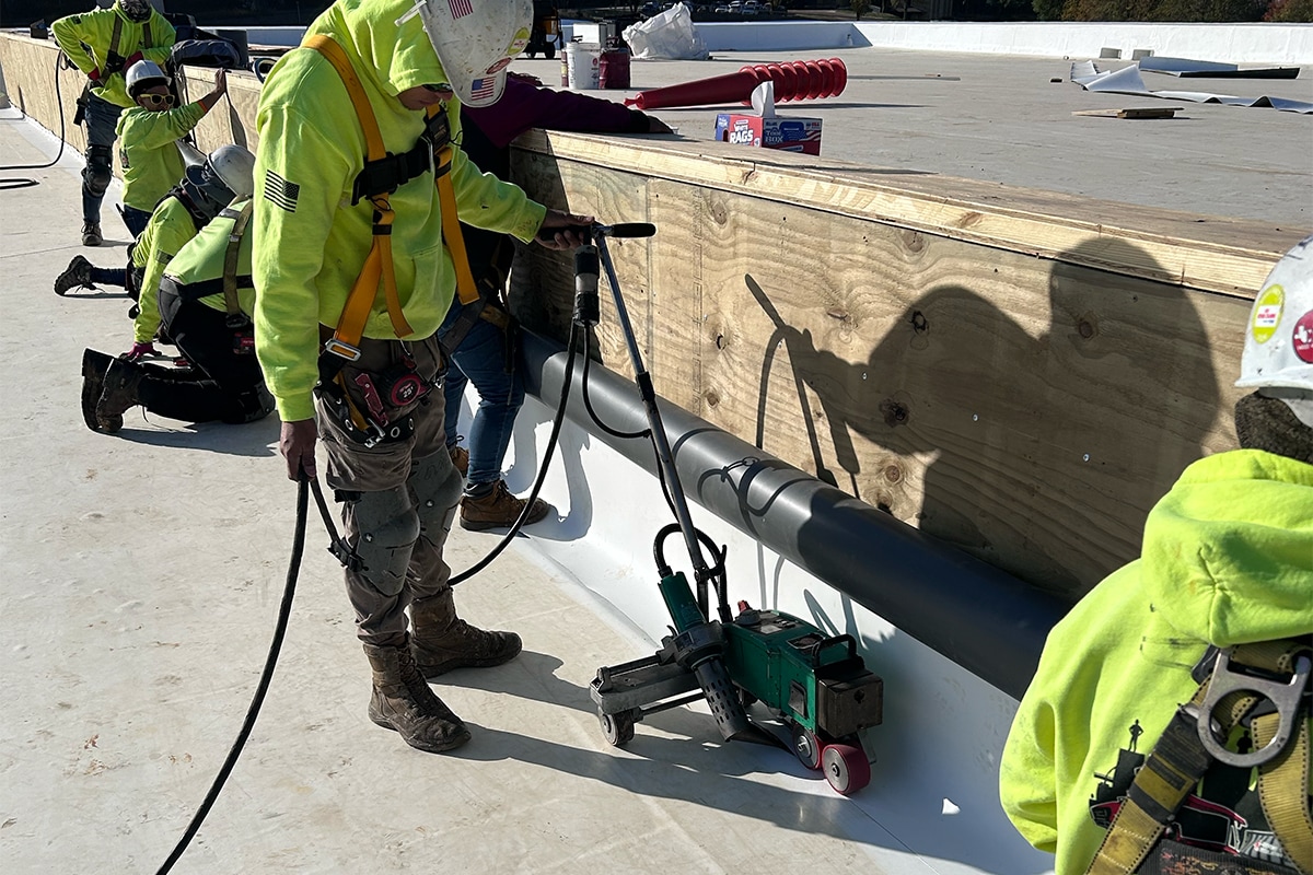 Roofing contractors working on the roof for the Goodwill of the Great Plains headquarters