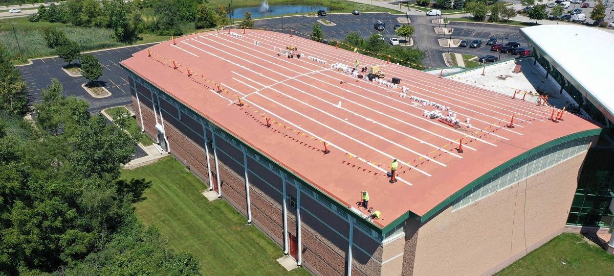 The Orland Park Sportsplex new roof coating in process, with the first coat of GAF Multi-Purpose Primer