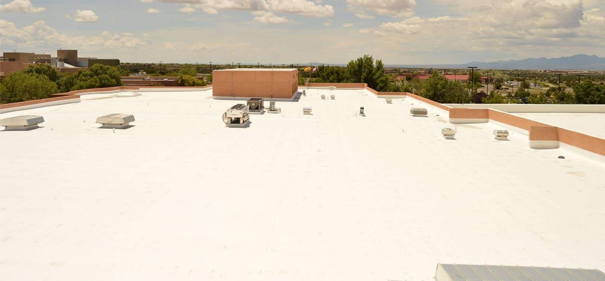 Side view of flat roof at Santa Fe Community College showcasing new roof coating