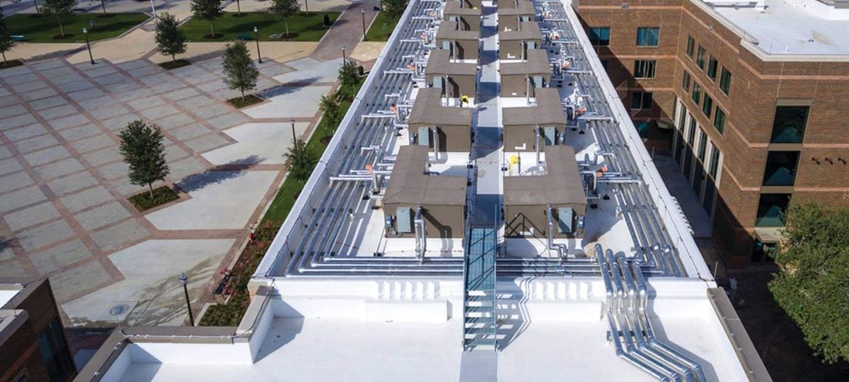 Aerial view of Texas A&M University buildings with pipes and other roof installation challenges