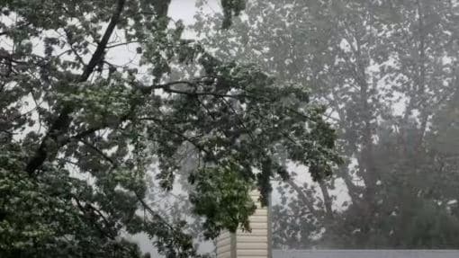 Storm with wind and rain outside of a house