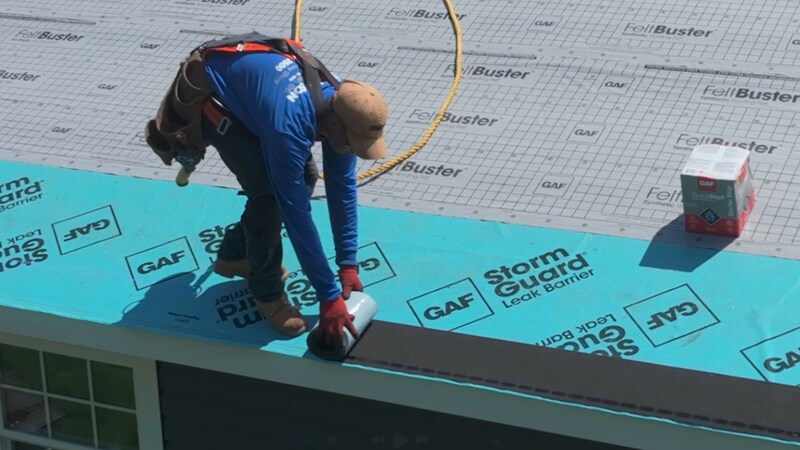 Roofer installing GAF QuickStart on a residential roof.