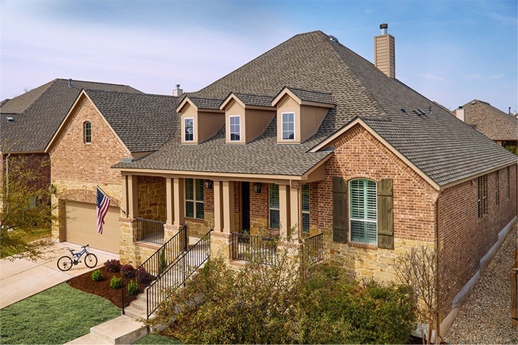  Light blue house with Timberline UHDZ® Shingles in Weathered Wood.