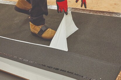 Step 2: Peeling release film from back of QuickStart starter roll.