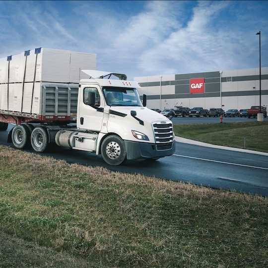 Truck with GAF products outside factory