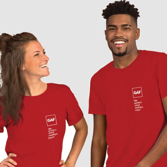 Man and woman wearing red GAF t-shirts.