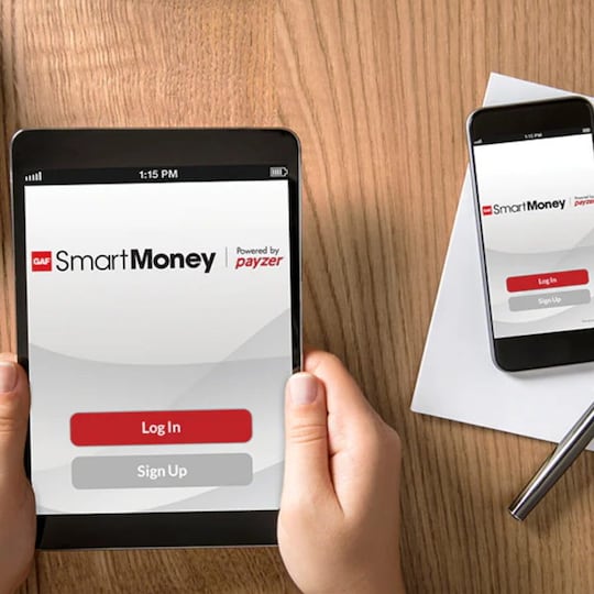 Hand holding tablet with GAF SmartMoney on screen