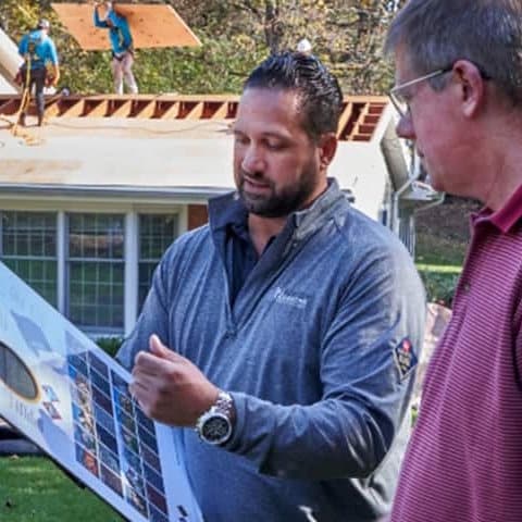 GAF contractor showing shingle color palette to homeowners.
