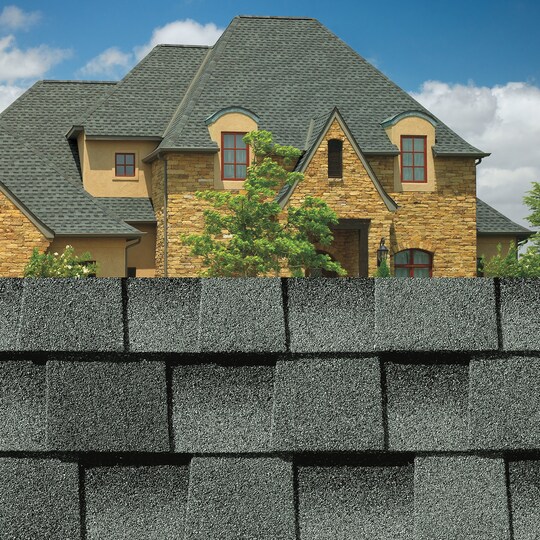 GAF Timberline HDZ® Slate Shingle closeup with sample product image on a  brick house.