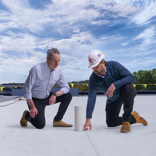 Architects on a building rooftop built with GAF materials