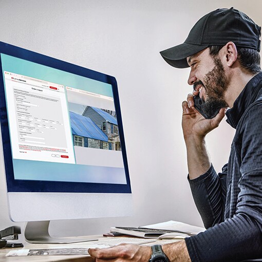 Roof contractor using GAF ScopeConnect service on computer
