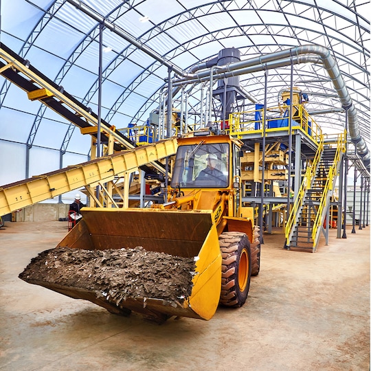 Machinery carrying old roof shingles