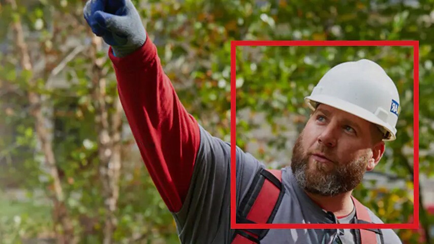 GAF contractor wearing a white hard hat pointing