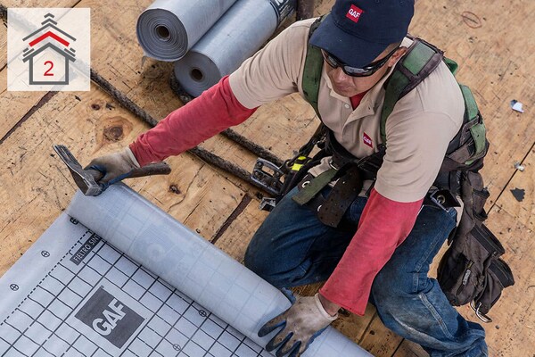 Contractor installing roof deck protection