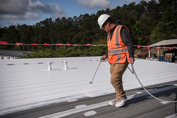 Roofers on top of commercial roof