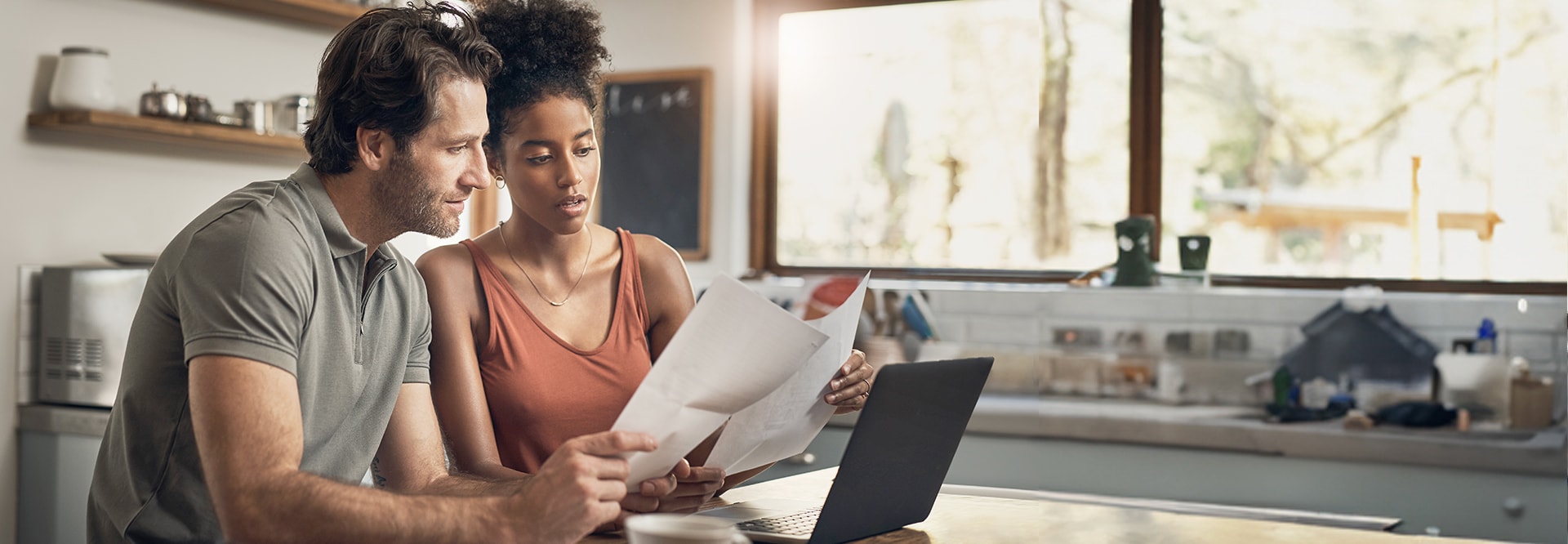 Homeowners reviewing roof damage insurance claim forms