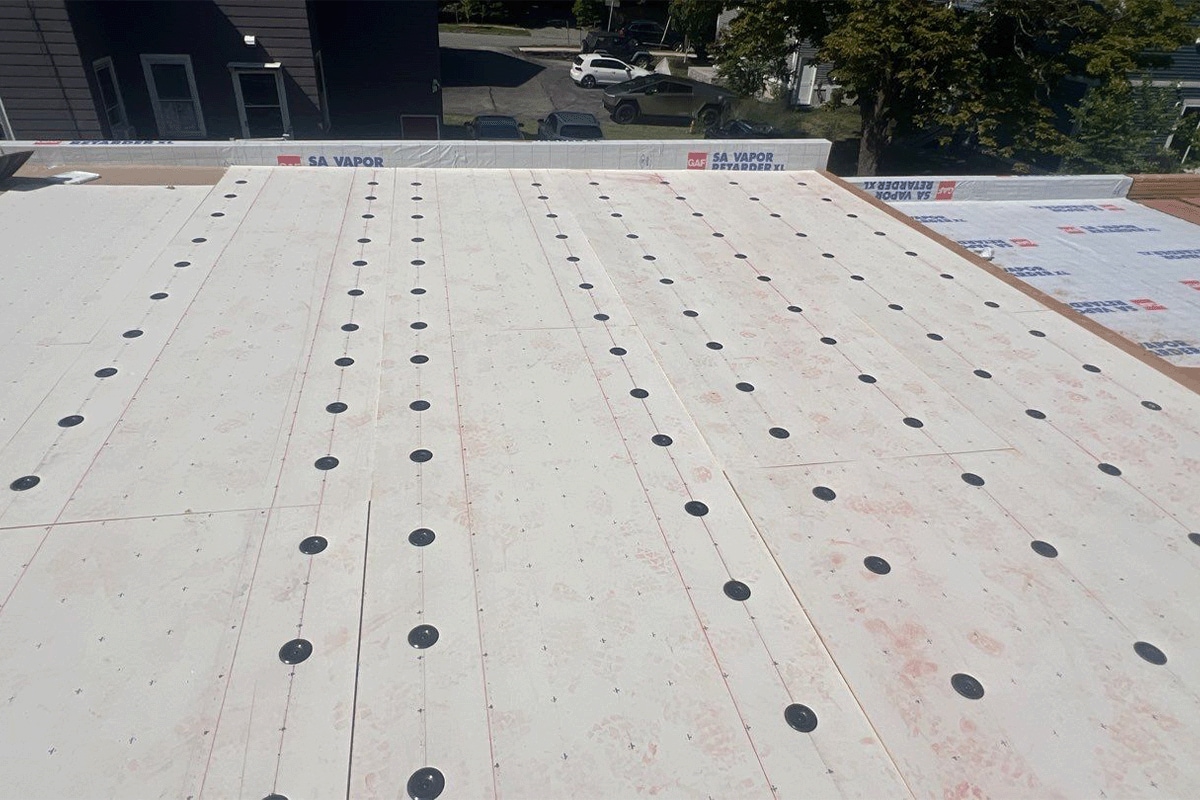 Layers of the GAF flat roof system being installed on the Getty Bagel Shop in NH.