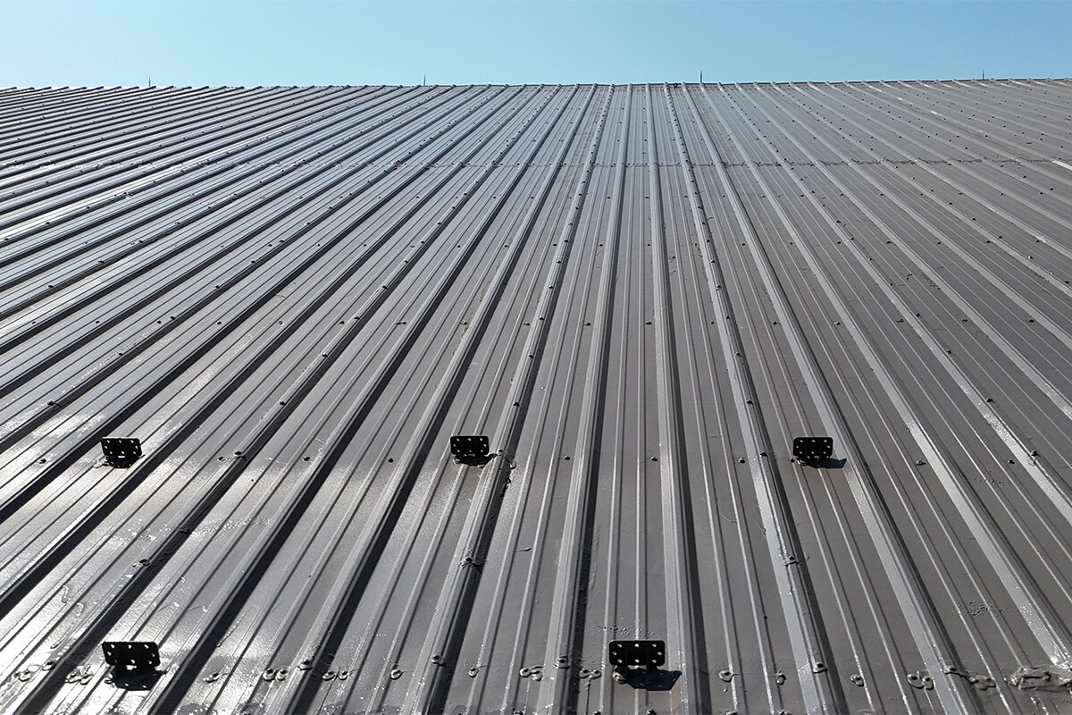 Close up of North Park Ice Arena silicone coating over metal restored roof.