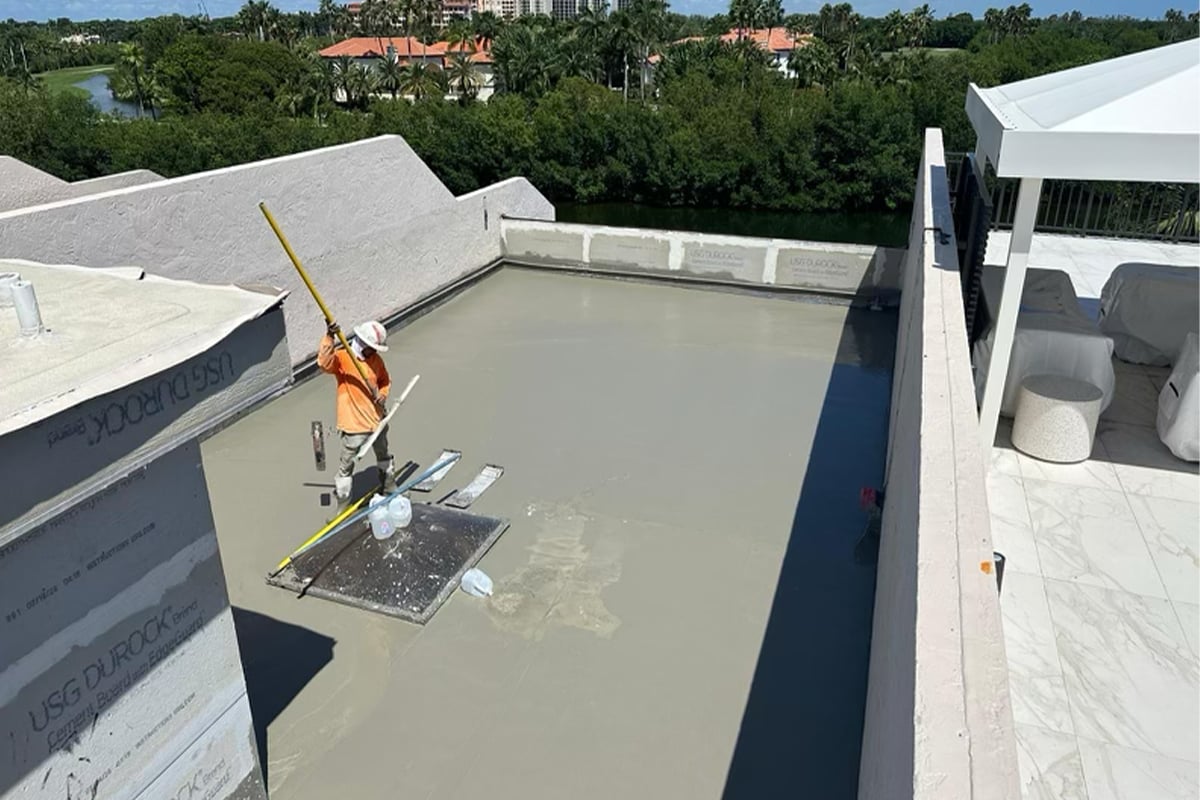 Aerial view of a GAF certified roofer installing a new roof on the Paradise Point Townhomes in Palmetto Bay, FL.