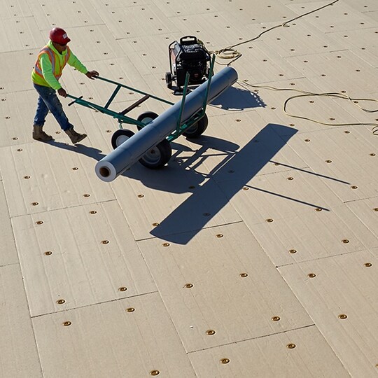 GAF employee working on a commercial roof