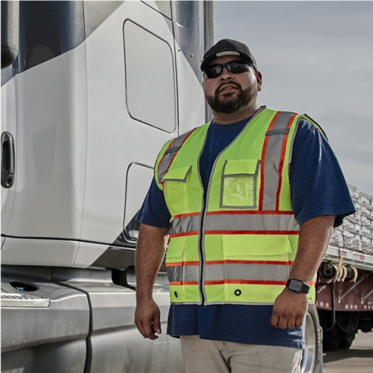 GAF employee outside flatbed truck with shingles