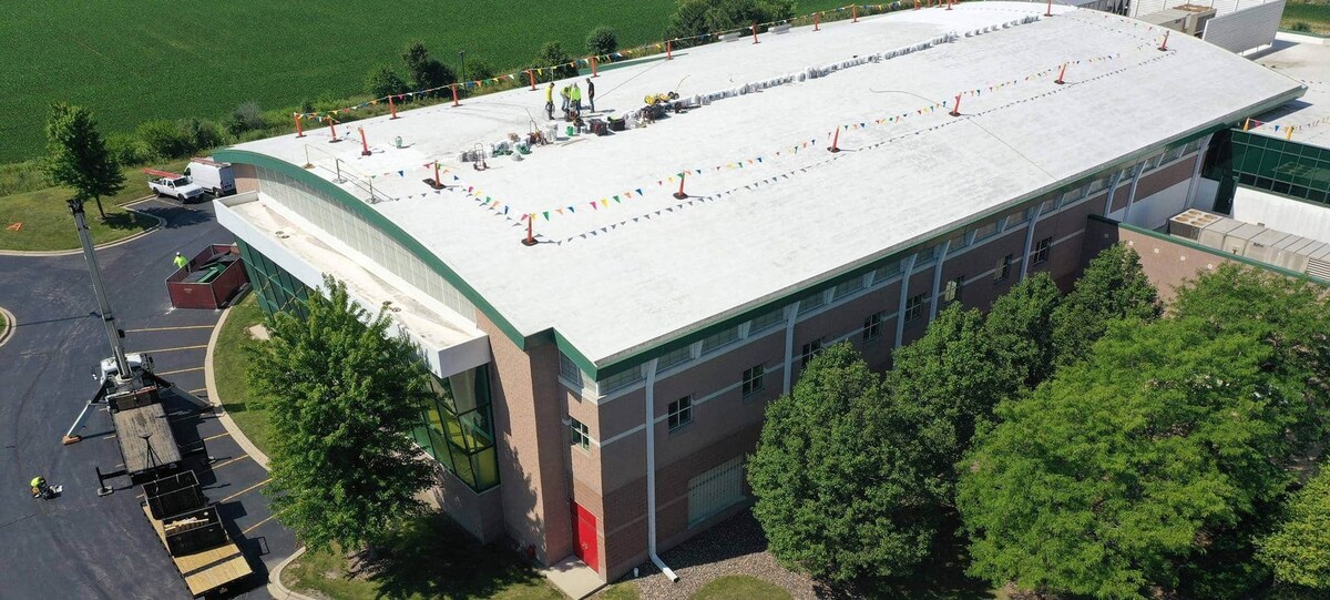 The Orland Park Sportsplex with GAF Unisil High Solids Silicone Roof Coating being applied