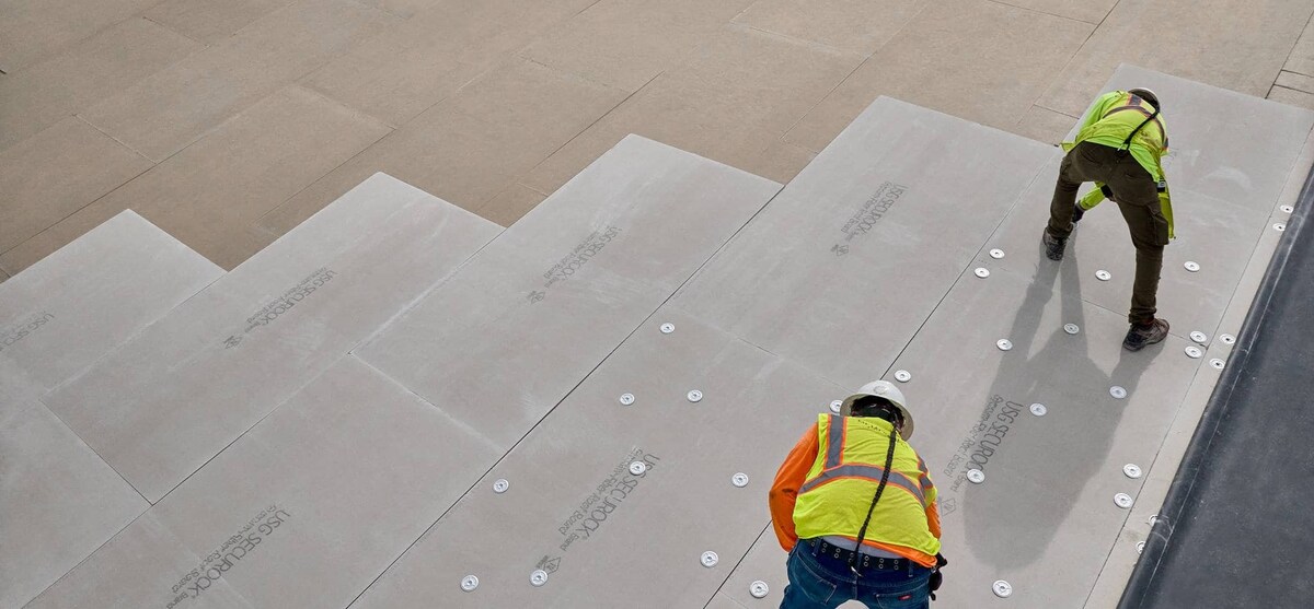 Contractors adhering new commercial roof on Savannah Convention Center
